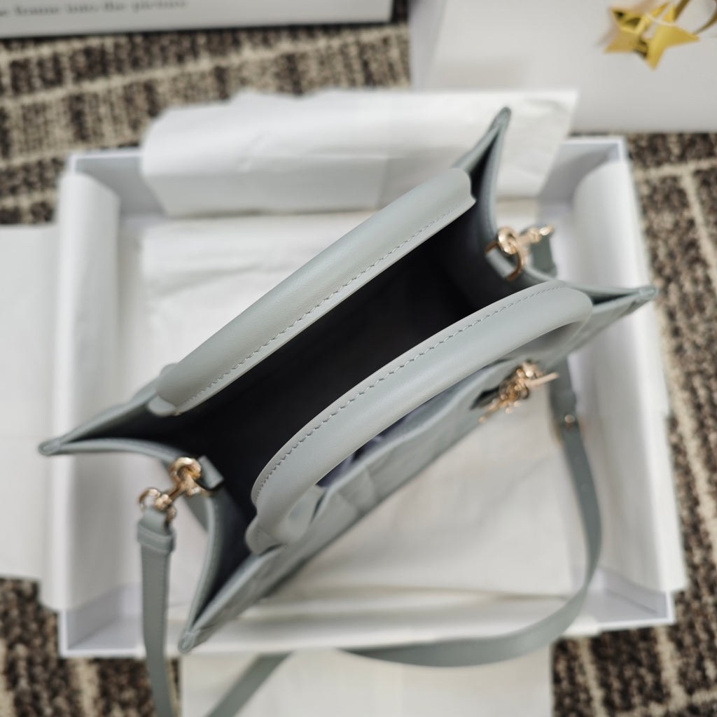 Dior quilted tote bag open view with light blue trim and gold-tone hardware