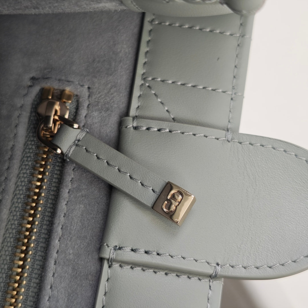 Dior zipper and small hardware detail on quilted light-blue bag interior