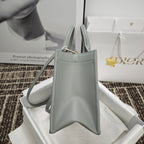Dior mini bucket bag with top handles and gold-tone chain clasp, light blue