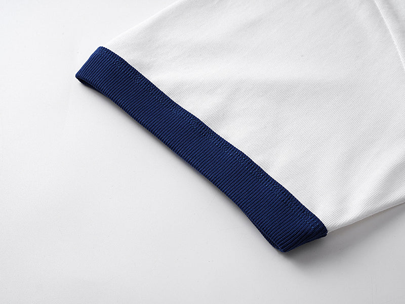 White short-sleeve T-shirt with navy cuff stripe detail at the sleeve hem