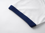 White short-sleeve T-shirt with navy cuff stripe detail at the sleeve hem