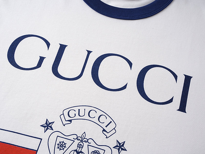 White short-sleeve T-shirt with large GUCCI lettering and crest graphic