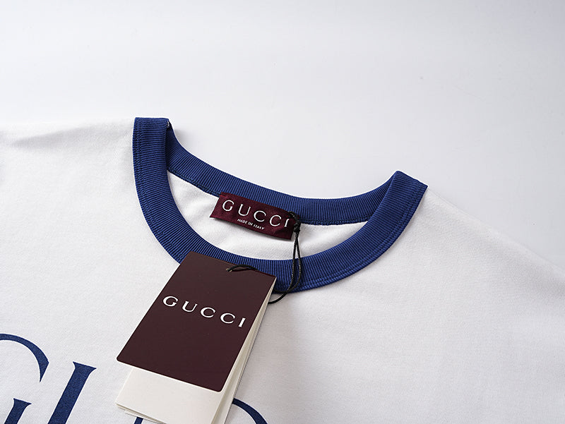 White short-sleeve T-shirt with navy ribbed collar and hanging Gucci brand tag