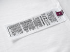 White short-sleeve T-shirt with size and care label at the inner hem