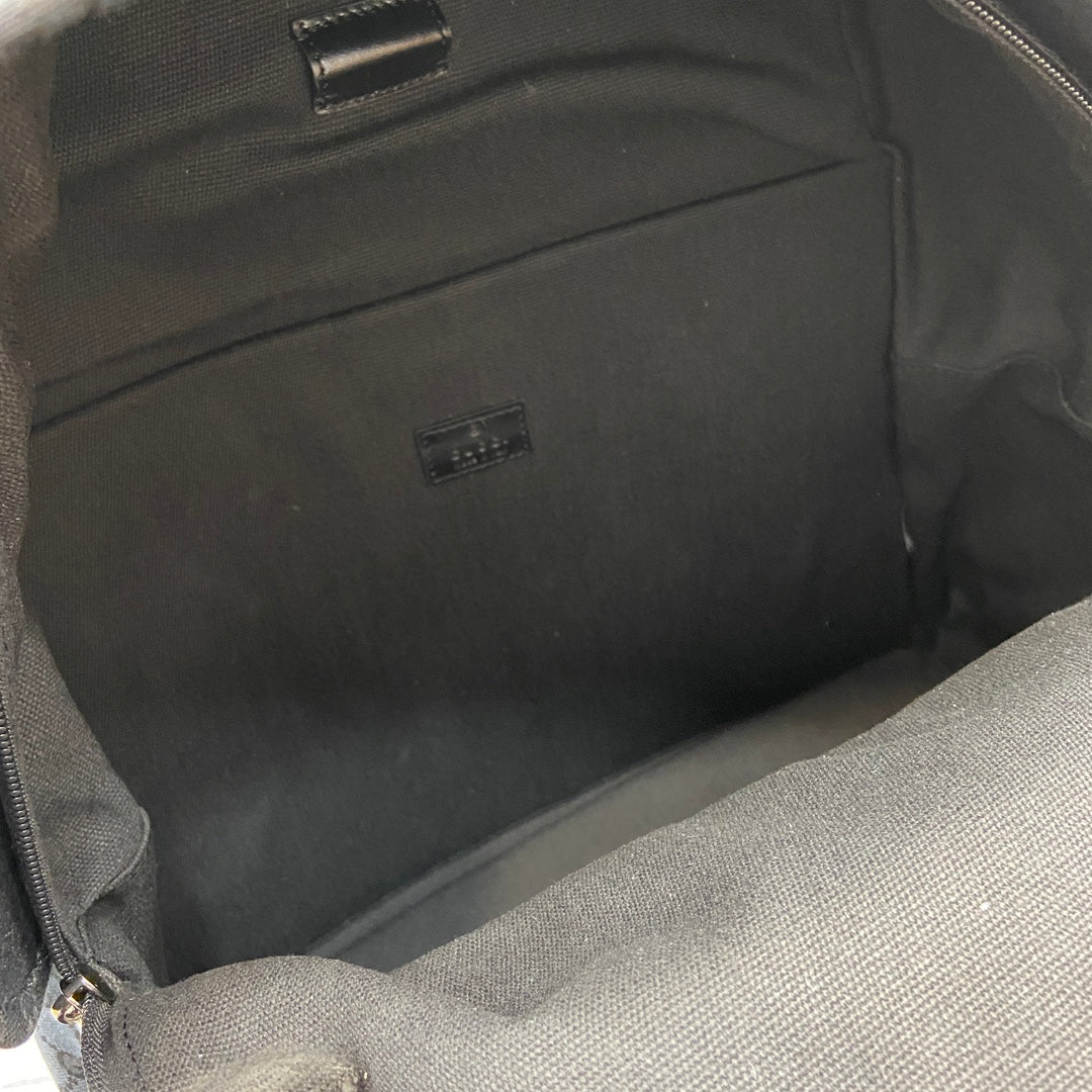 Gucci men's backpack interior lining with small label tag and zippered compartment wall