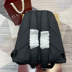 Gucci men's dark monogram backpack back view with padded straps and top seam detailing