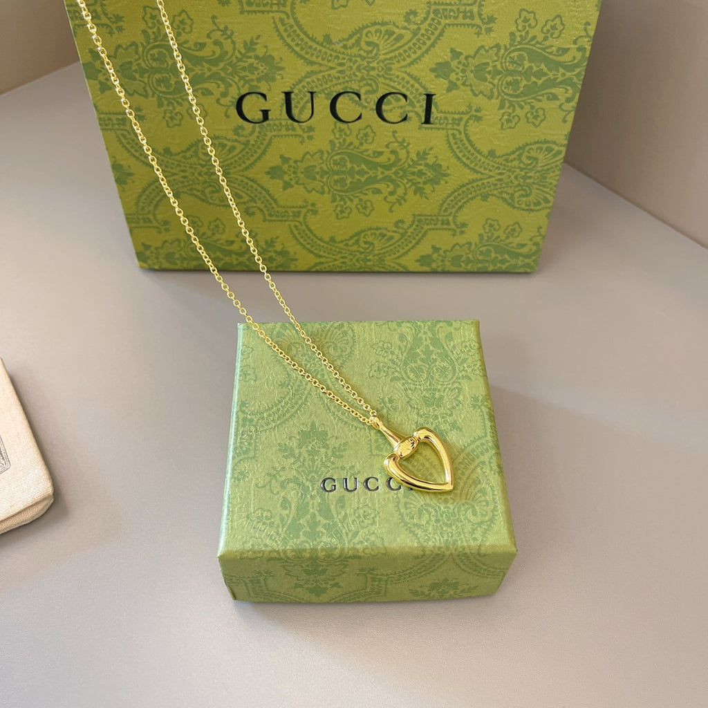 Gold-tone heart pendant necklace with fine chain and lobster-claw clasp