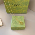 Gold-tone heart pendant necklace with fine chain and lobster-claw clasp