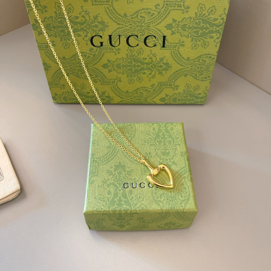 Gold-tone heart pendant necklace with fine chain and lobster-claw clasp