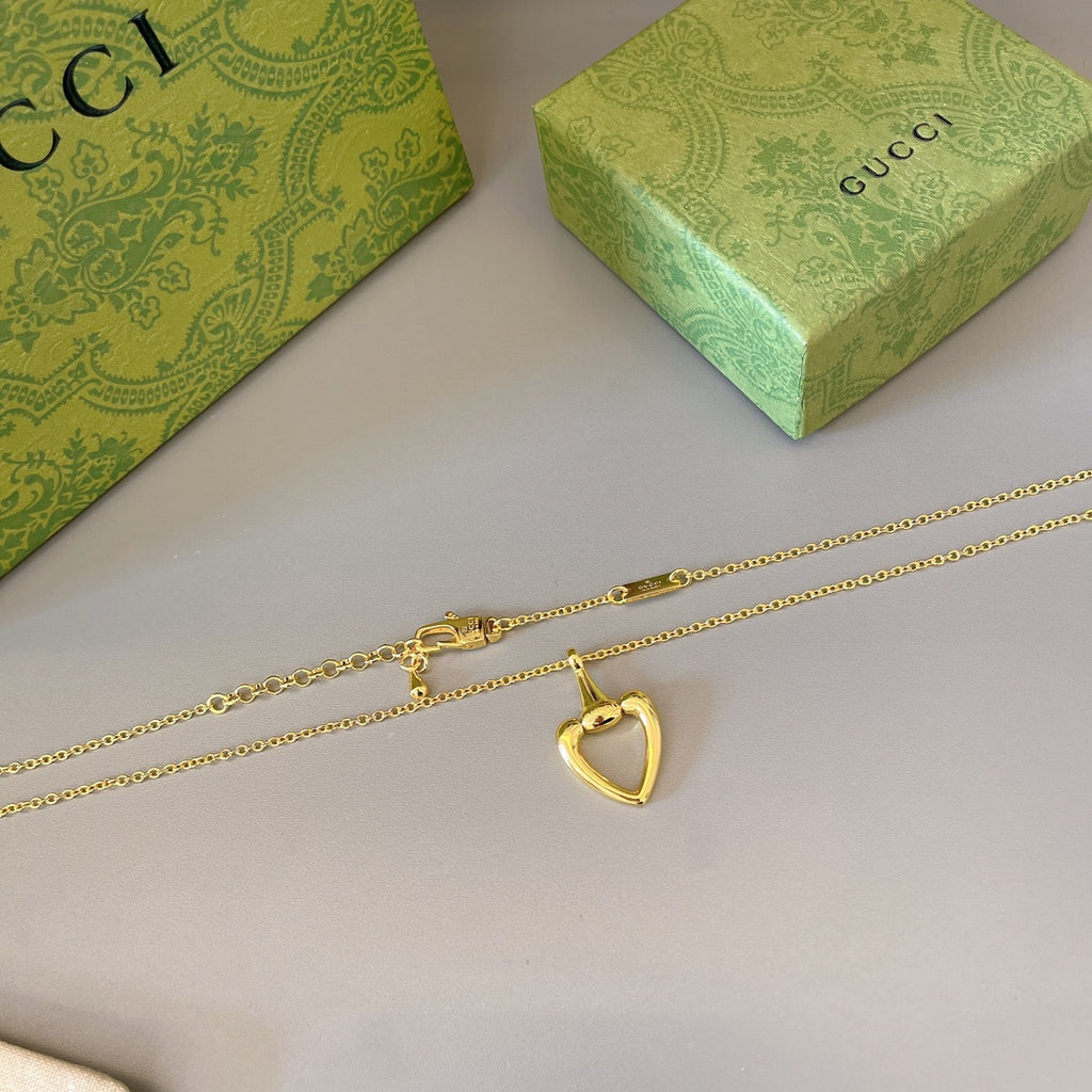 Gold-tone heart pendant necklace with layered chain and small clasp hardware