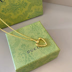 Gold-tone heart pendant necklace with heart charm and fine chain links