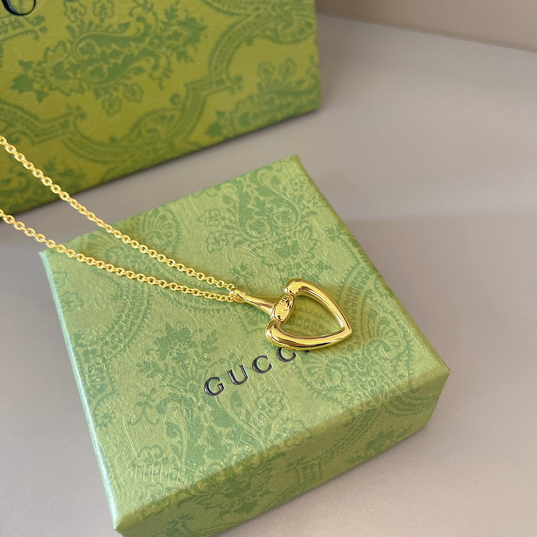 Gold-tone heart pendant necklace with heart charm and fine chain links