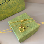 Gold-tone heart pendant necklace with chain and small link detailing