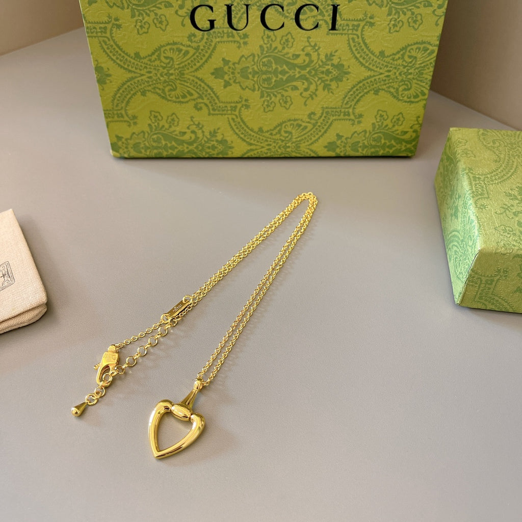 Gold-tone heart pendant necklace with small end charm and extended chain