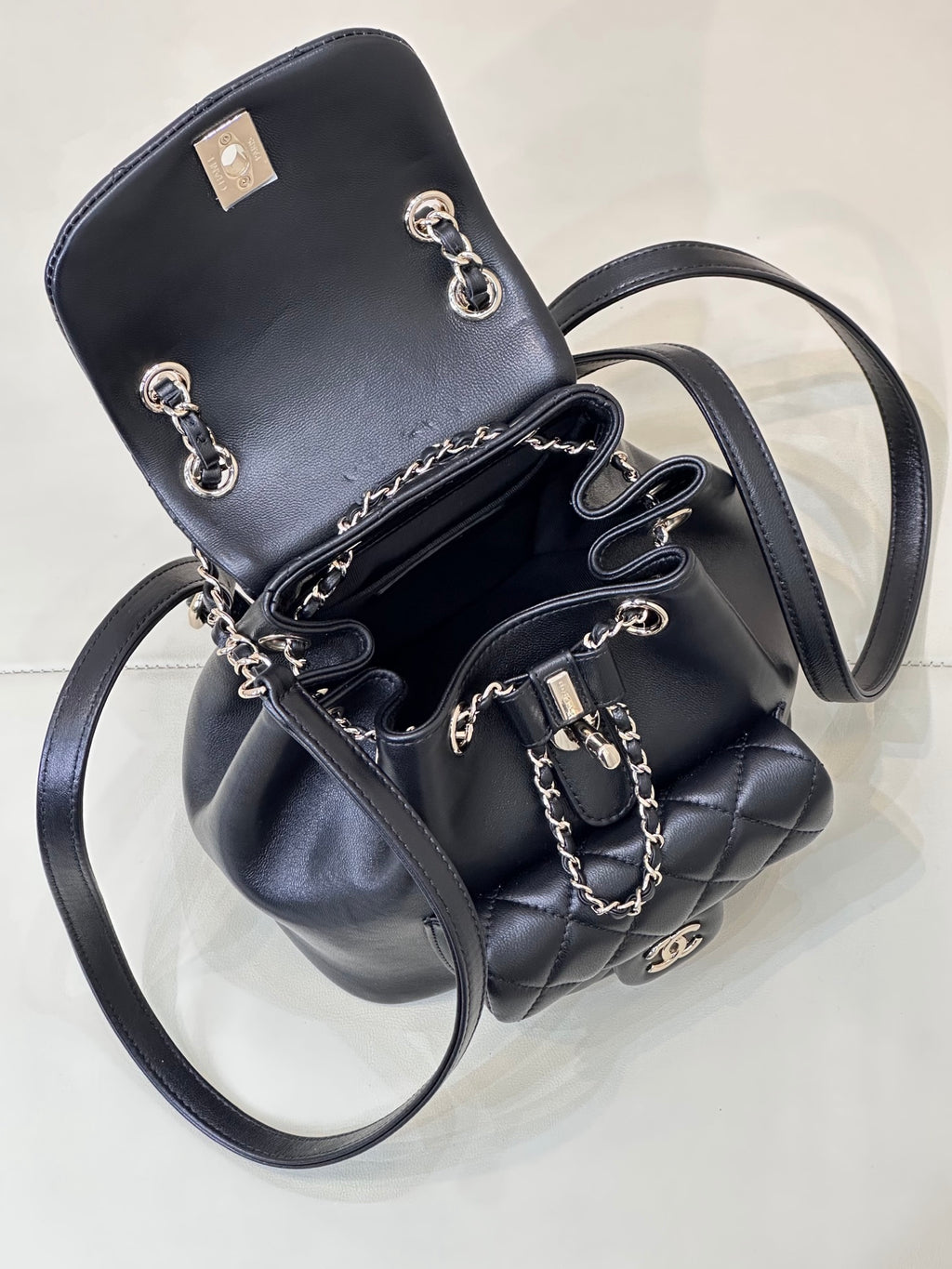 Dark navy quilted leather mini bag with chain shoulder straps and top flap