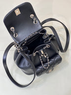 Dark navy quilted leather mini bag with chain shoulder straps and top flap