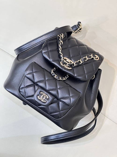 Dark navy quilted leather bag with chain strap, front flap and CC logo
