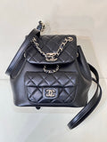 Dark navy quilted leather bag with chain strap, front flap and CC logo