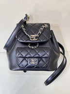 Dark navy quilted leather bag with chain strap, front flap and CC logo