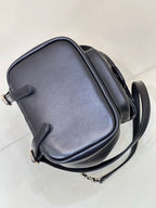 Dark navy leather crossbody bag with curved flap and chain shoulder strap