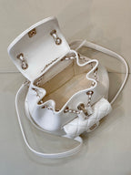 Chanel quilted leather bag with open top, showing interior and gold-tone chain hardware