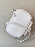 Chanel leather crossbody bag with top zip, rounded silhouette, and small gold-tone pull