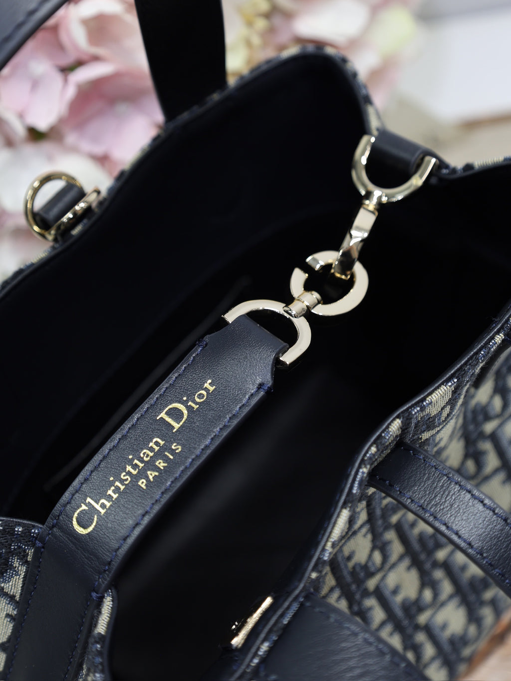 Dior bag interior with black lining and gold-tone key fob hardware