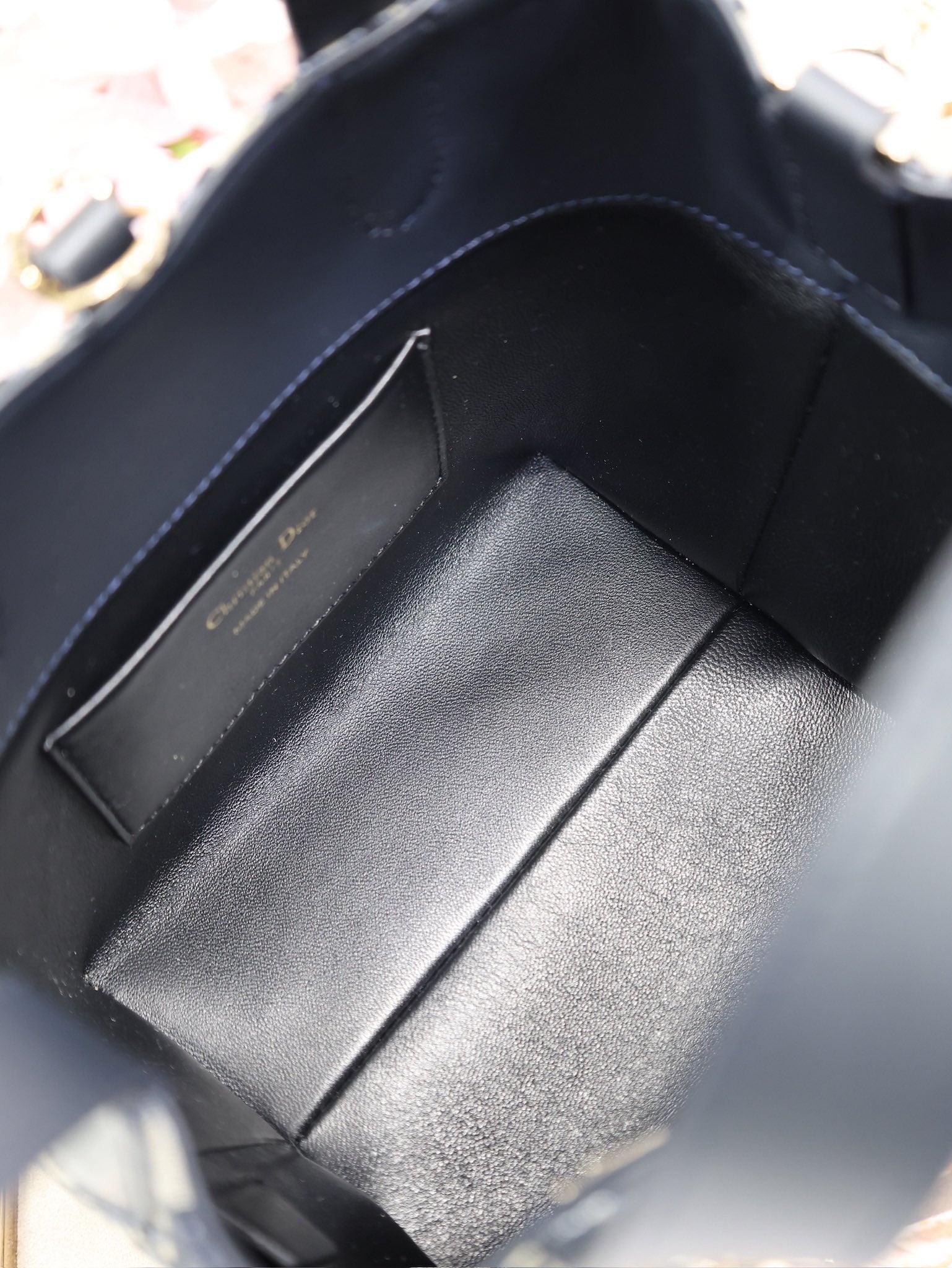 Dior bag interior pocket with black leather lining and divider
