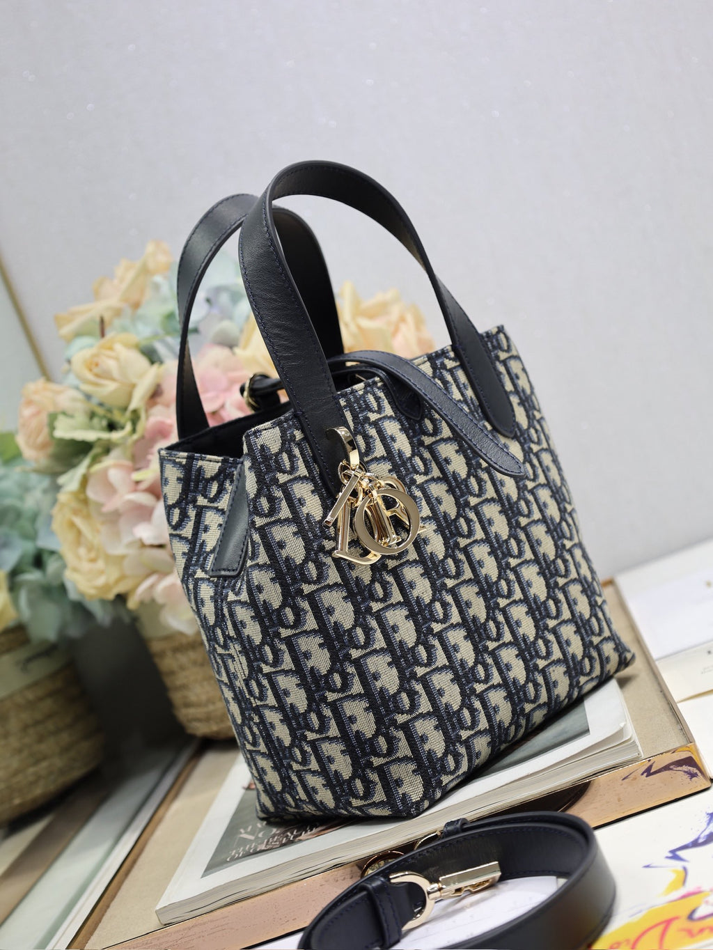 Dior small top-handle bag in navy and black Dior canvas with gold hardware and strap