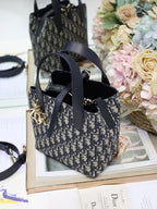 Dior top-handle bag in navy/black Dior canvas with front logo charm and shoulder strap