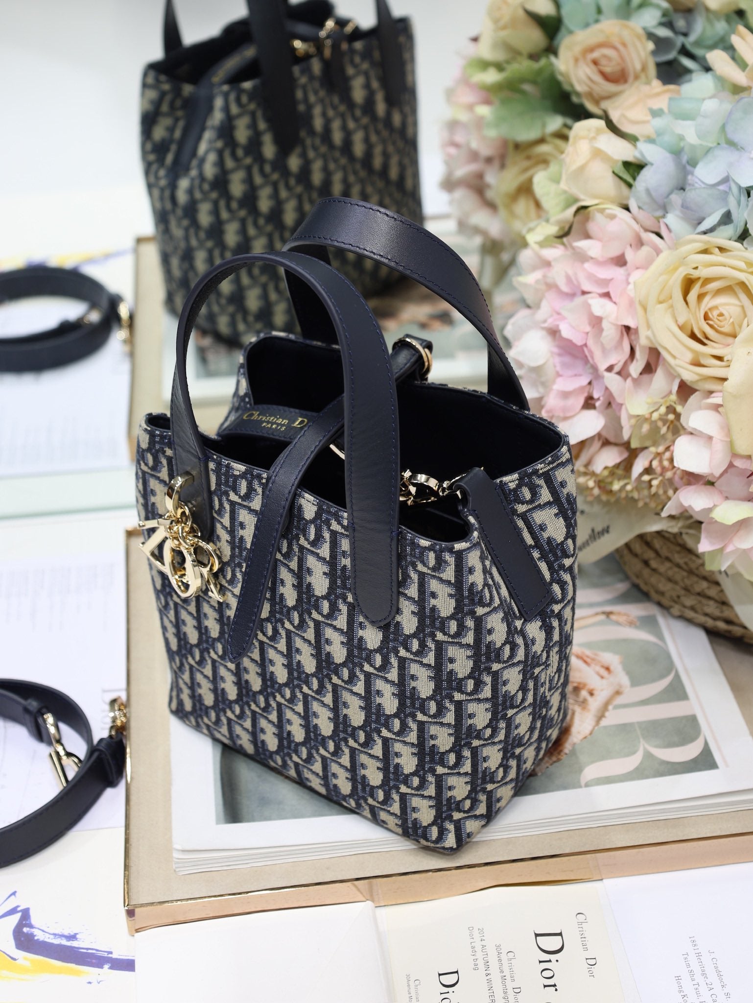 Dior top-handle bag in navy/black Dior canvas with front logo charm and shoulder strap