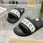 Black Gucci slide sandals with white logo strap, close-up of front and top