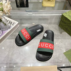 Black Gucci slide sandals, side view with green and red logo strap