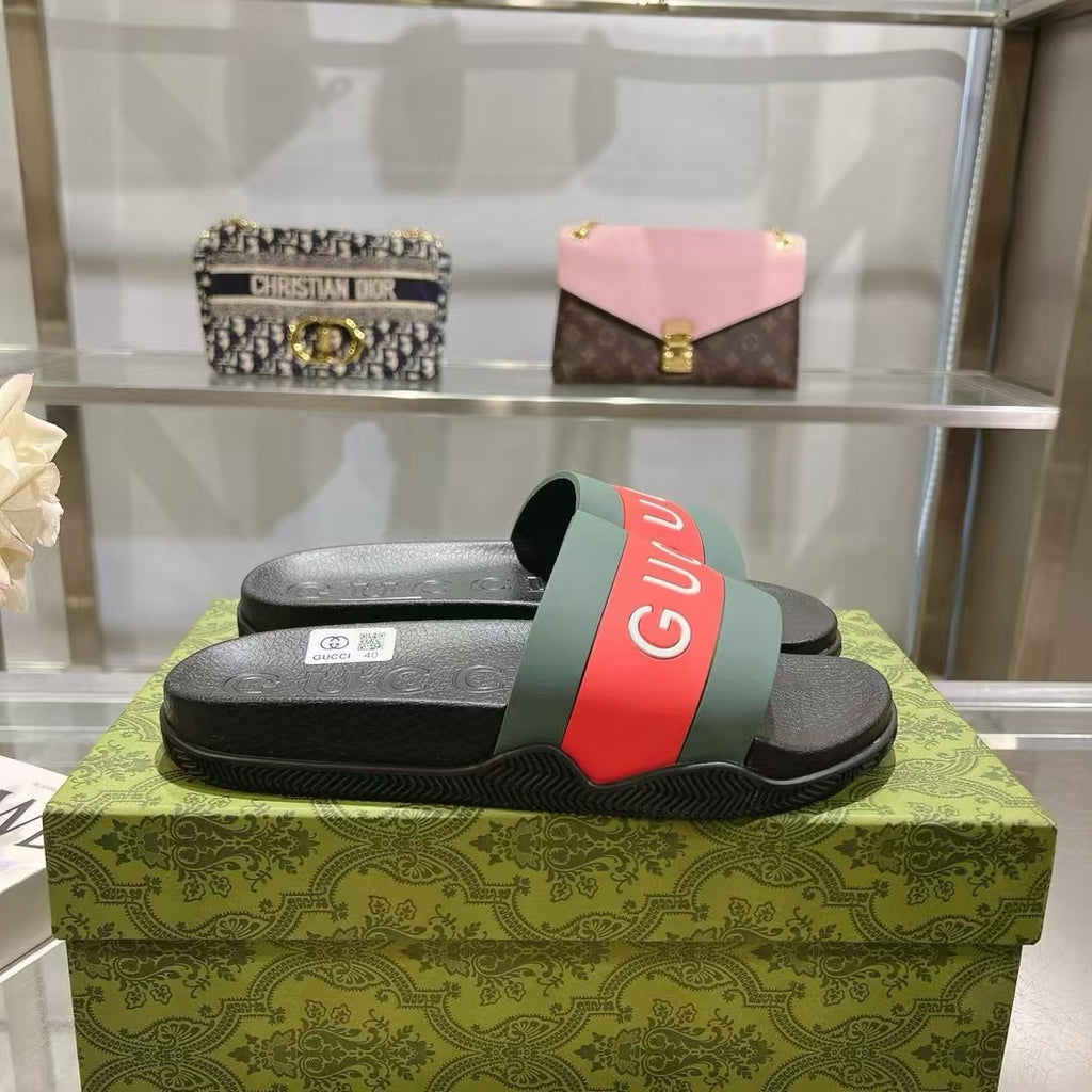 Black Gucci slide sandals on green box, green and red logo strap