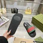 Gucci slide sandals showing treaded outsole and black footbed with logo strap