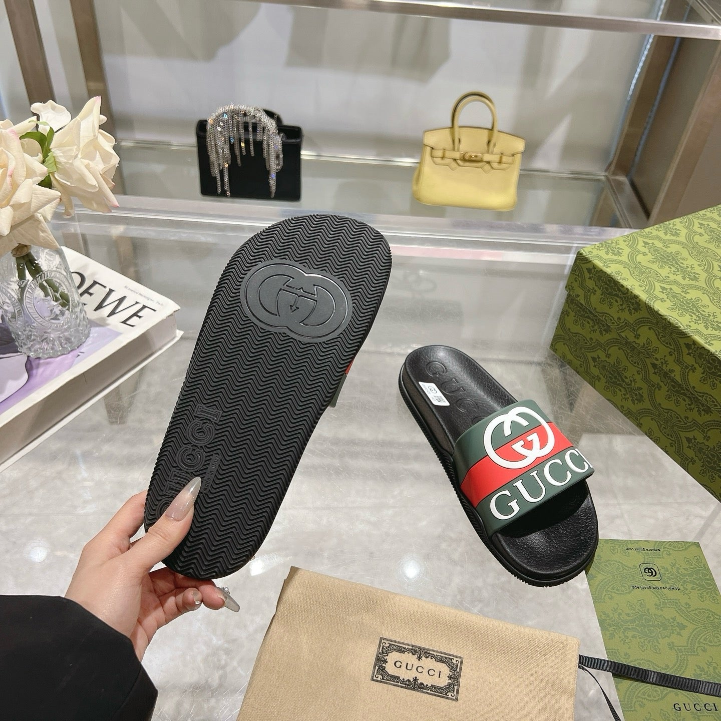 Gucci slide sandal outsole and strap, textured black sole with green-red logo