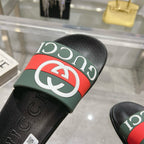 Gucci slide sandal strap close-up, green and red webbing with white logo