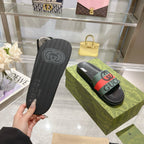 Black Gucci slide sandal outsole with tread pattern and molded logo.