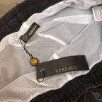 Versace shorts with breathable mesh-style texture, black elastic waist, logo label inside.