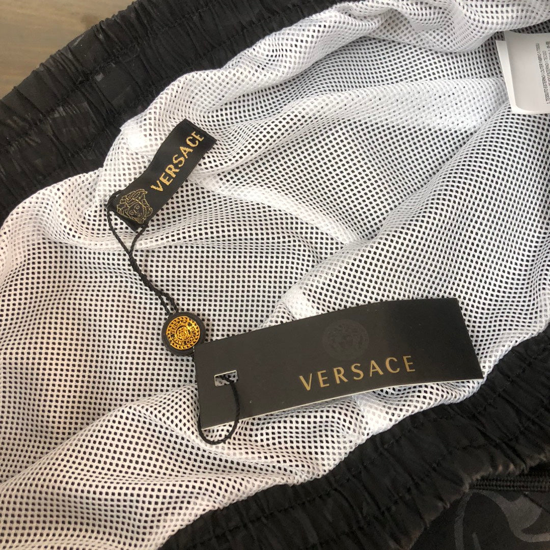 Versace shorts with breathable mesh-style texture, black elastic waist, logo label inside.