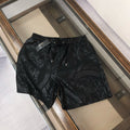 Versace black patterned shorts with elastic waistband and drawstring, all-over print.