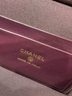 Maroon Chanel label reading “CHANEL” and “MADE IN ITALY” on handbag lining
