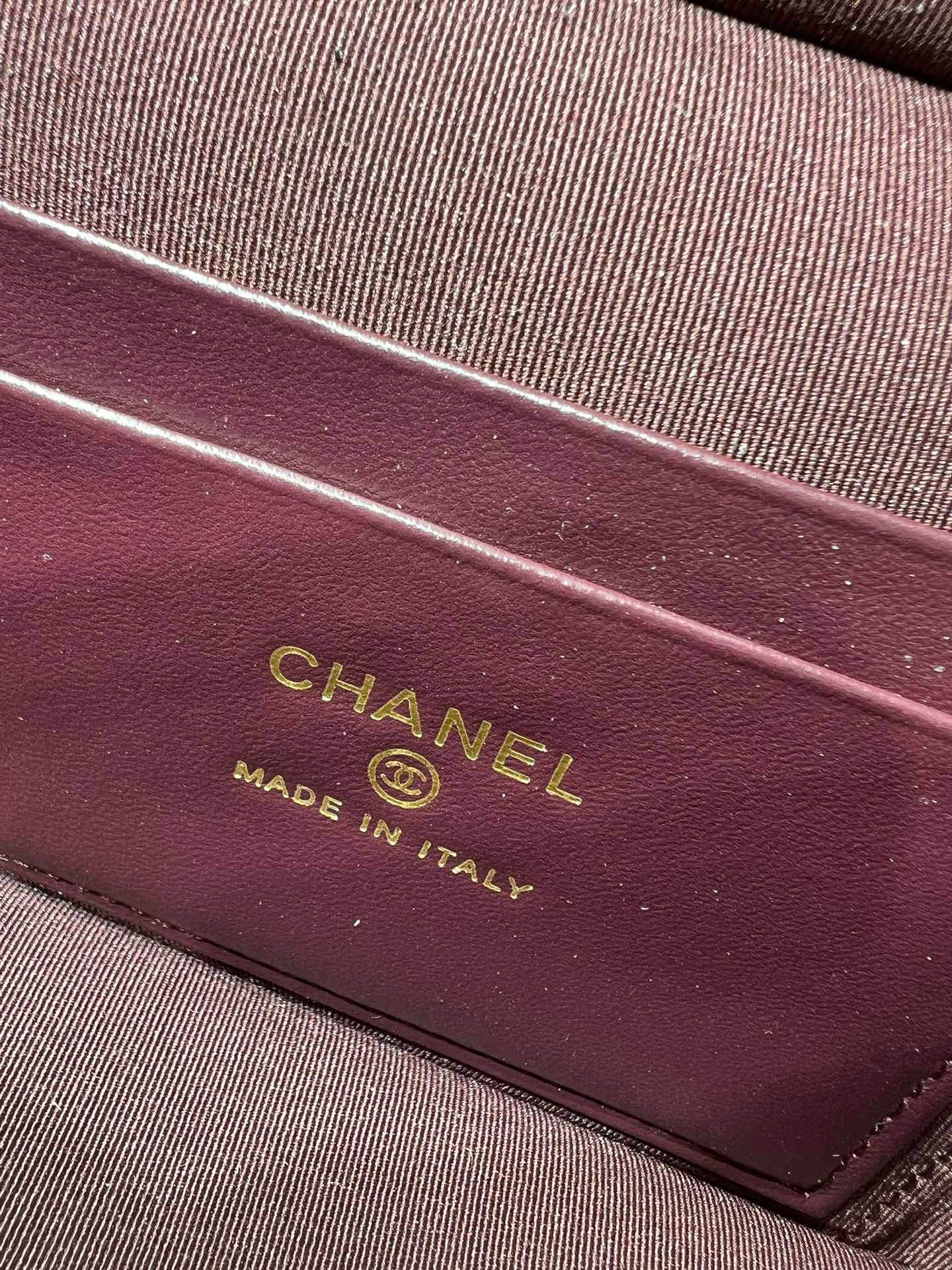 Maroon Chanel label reading “CHANEL” and “MADE IN ITALY” on handbag lining