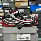 Chunky sneaker with ridged sole in black, gray, and red accents, side/front view