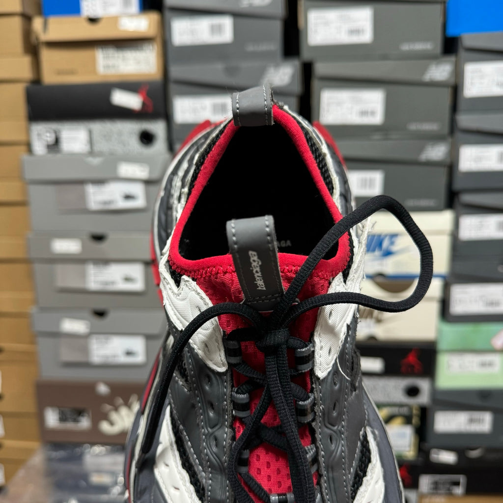 Back of chunky sneaker with red collar lining and black lace-up hardware