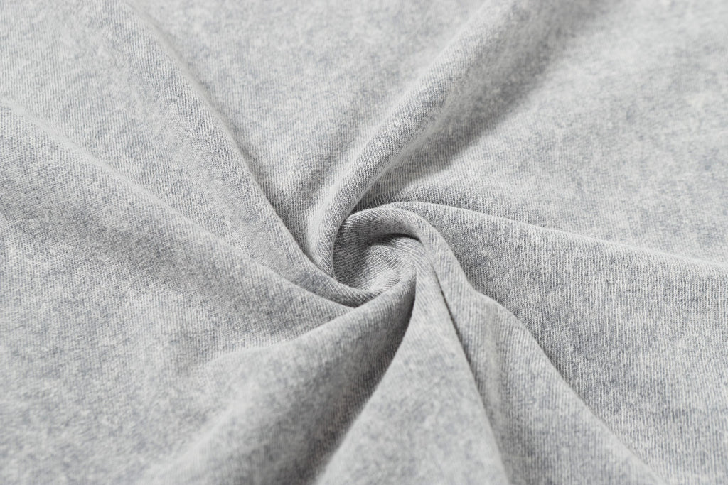 Light gray T-shirt fabric close-up with soft folds