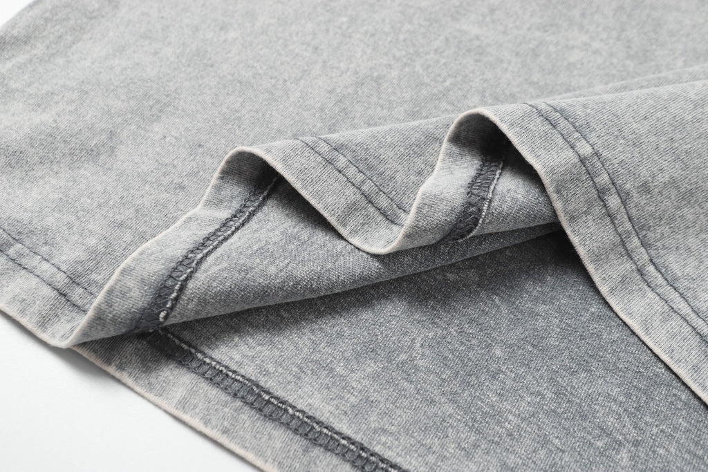 Light gray T-shirt sleeve seam and cuff stitching detail