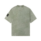 Back of short-sleeve T-shirt in sage green, crew neck, small black side logo patch