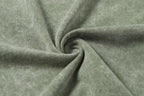 Sage green T-shirt fabric close-up with soft knit texture twist