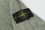 Stone Island T-shirt in sage green with black chest patch and neon green emblem